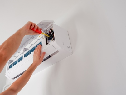 technician checks air conditioner